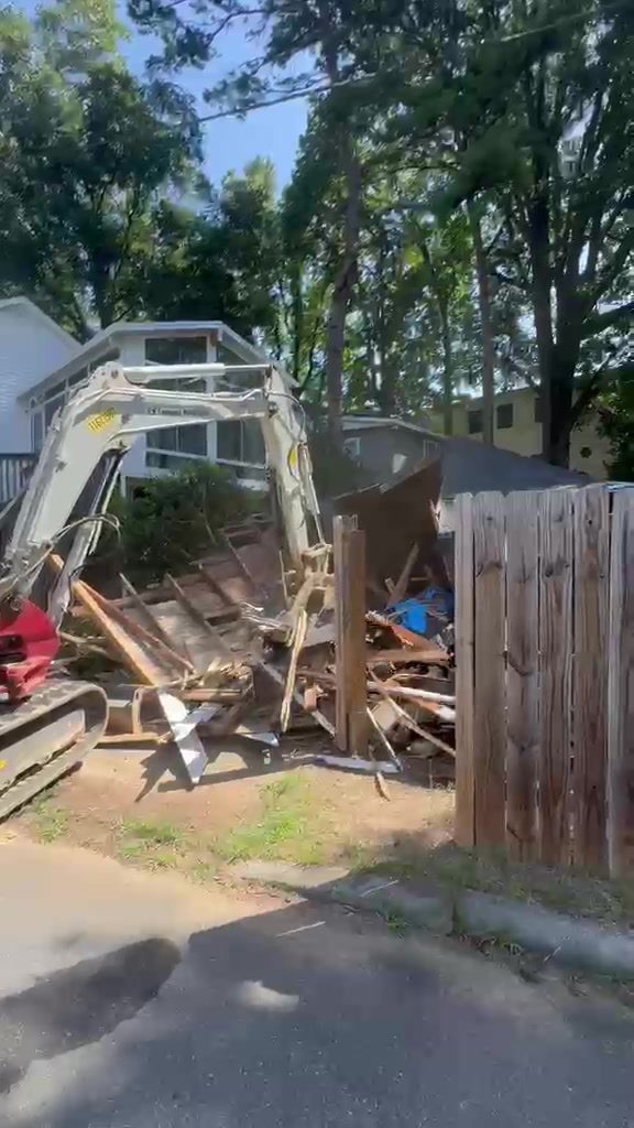 Excavator pulling house walls inward during demolition in Cornelius NC