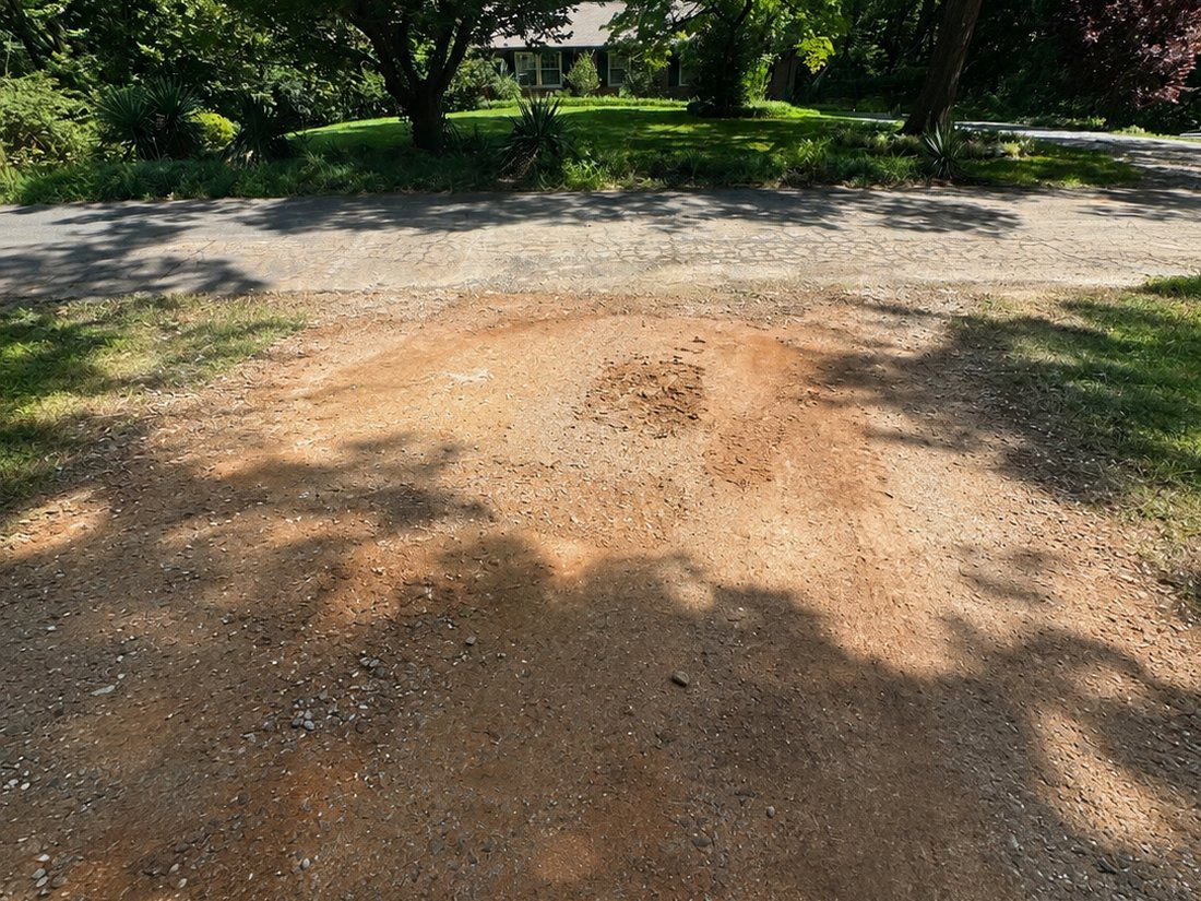 Before: bare clay driveway