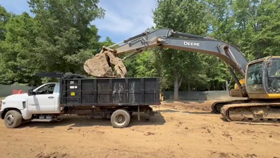Dump truck loaded with debris and spoil ready to haul off a job site near Charlotte NC