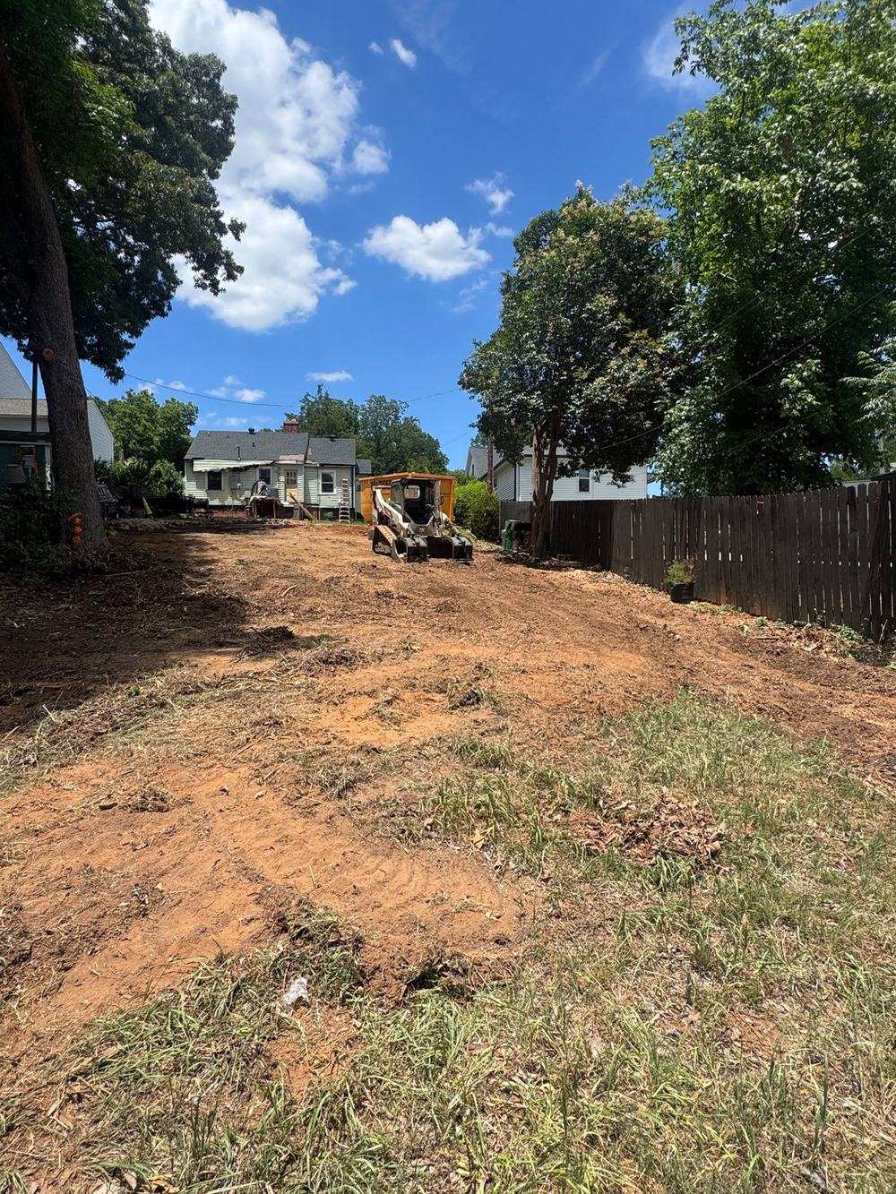 Backyard lot cleared to bare workable ground after property cleanup in Huntersville NC